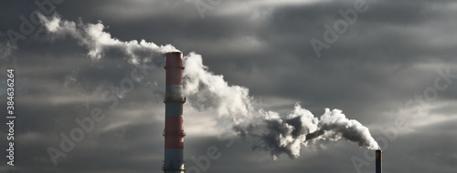 Panoramic view of the large central heating station in dramatic light. Pipe close-up. Ecology, ecological issues, fuel and power generation, environmental damage. Dark industrial cityscape