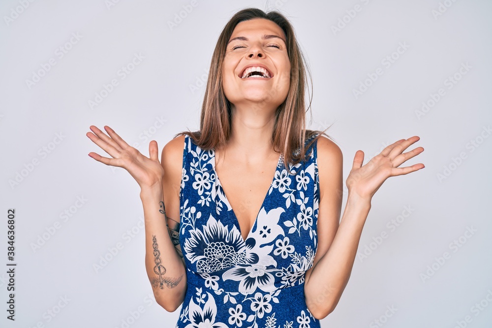 Beautiful caucasian woman wearing casual clothes celebrating mad and crazy for success with arms raised and closed eyes screaming excited. winner concept Beautiful caucasian woman wearing casual clothes celebrating mad and crazy for success with arms raised and closed eyes screaming excited. winner concept