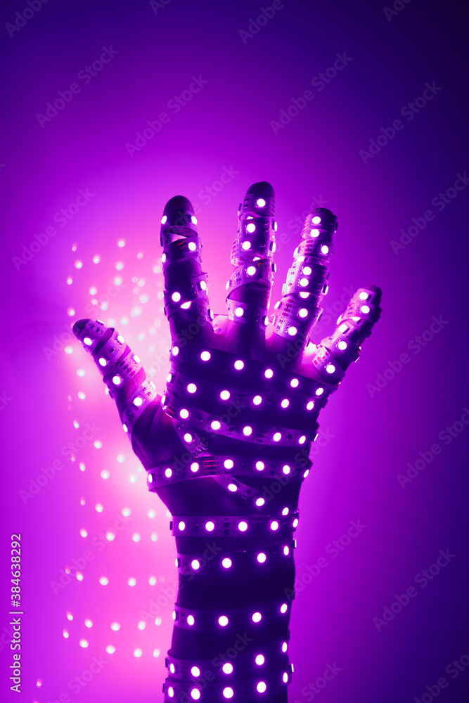 human hand covered with purple led lights, illuminated background human hand covered with purple led lights, illuminated background