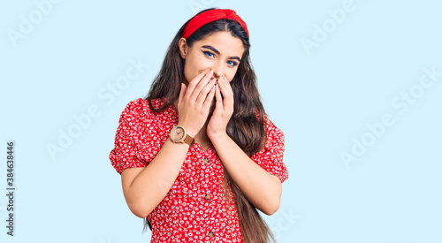 Fotografie Brunette teenager girl wearing summer dress laughing and embarrassed giggle cove