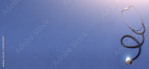 Gray stethoscope top view. Stethoscope with reflection. Stethoscope background. Stethoscope with reflection on blue background.
