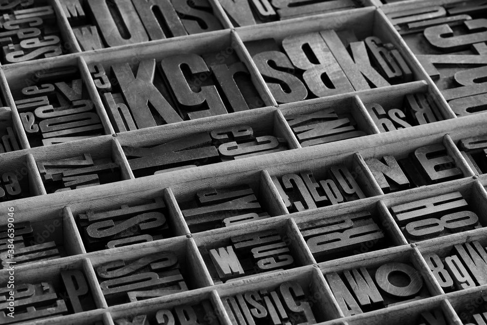 Old letterpess background. Collection of vintage block letters made of
