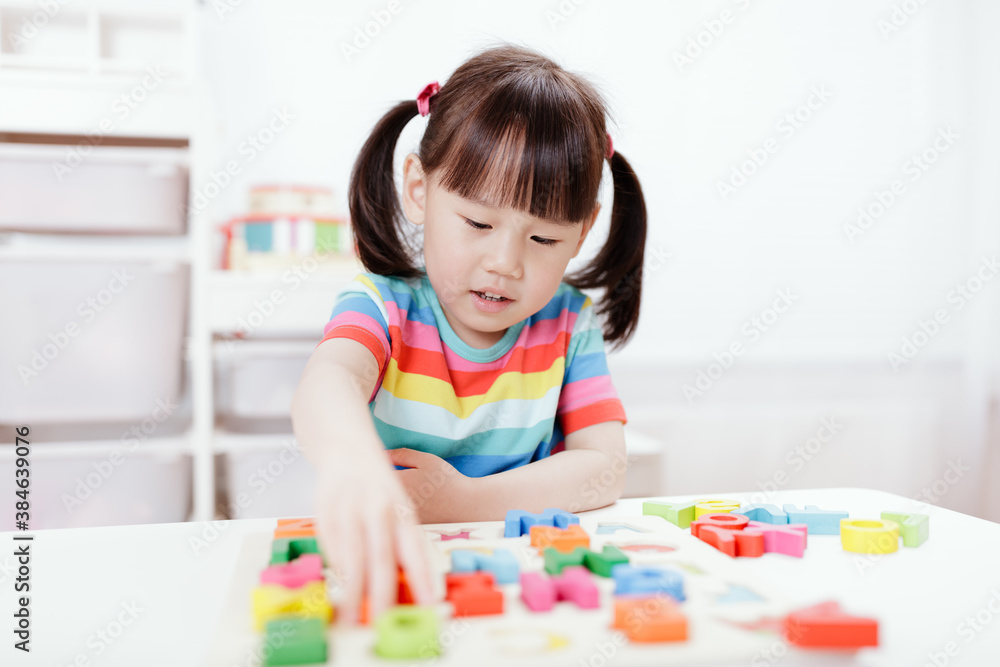 young girl learning letter blocks for homeschooling young girl learning letter blocks for homeschooling