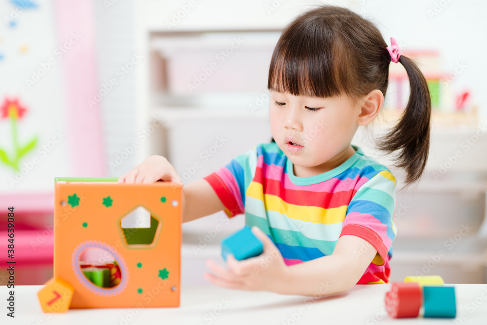 young girl playing number shape blocks for homeschooling young girl playing number shape blocks for homeschooling