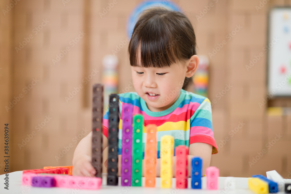 young girl play number blocks for homeschooling young girl play number blocks for homeschooling