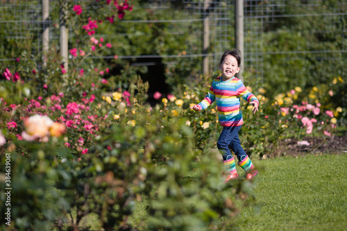 young girl running in the summer garden in the morning