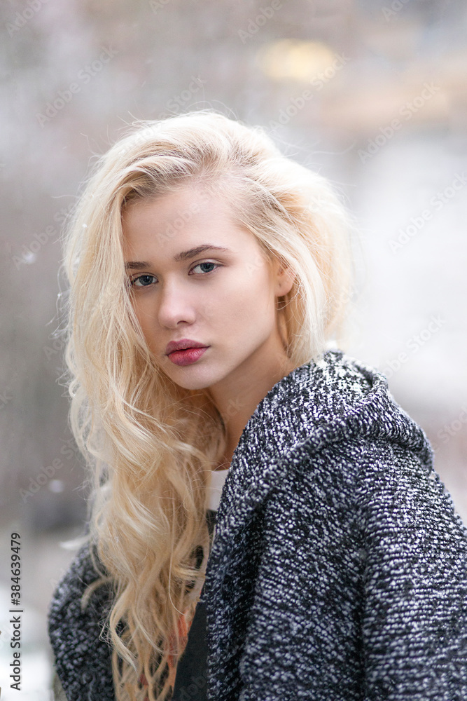 Closeup portrait of young beautiful blond woman face posing outside in winter time. Closeup portrait of young beautiful blond woman face posing outside in winter time.