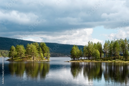Lofsdalen, Sweden. View of the wooded shore and the island from Lofssjön lake.