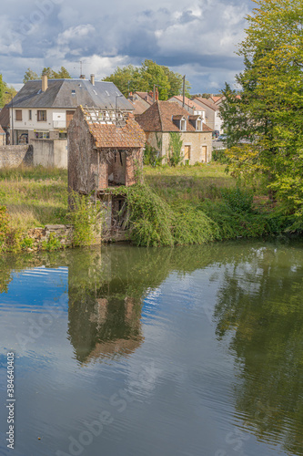 Alençon, France - 10 04 2020: Reflections of an old ruined house on the river