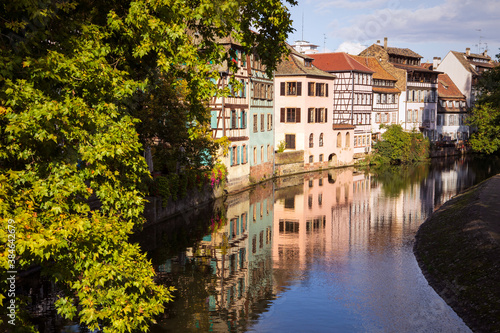 Scenic view on a canal and buildings in Strasbourg city, little france, old town district. Street with architecture reflecting in water. Alsace, France