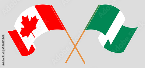 Crossed and waving flags of Nigeria and Canada
