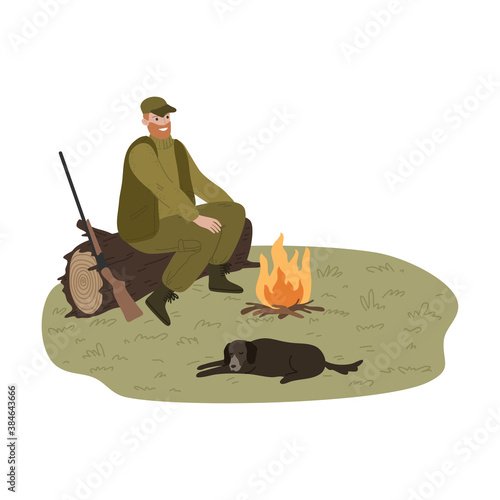 Man hunter warming up near fire with dog during hunting