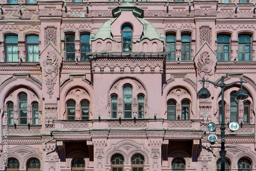 Ostrovsky Square, Saint Petersburg, Russia, 11.10.2020. Pink red historical building Bazin's House in Russian style. Decorative facade with turrets, windows, stucco.