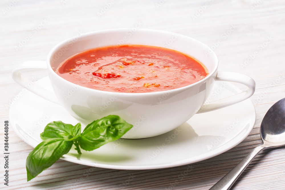 Gazpacho in a white plate and basil Gazpacho in a white plate and basil