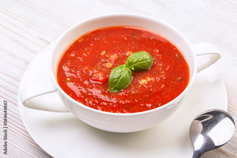 Gazpacho in a white plate and basil Gazpacho in a white plate and basil