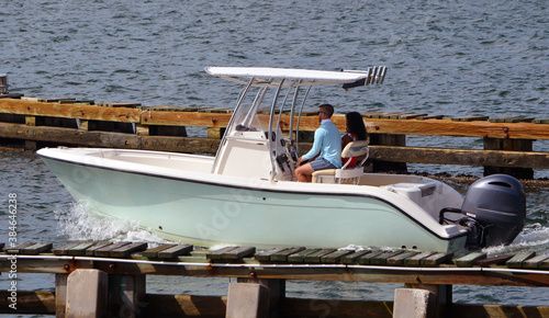 Couple taking a leisurely cruise on the Florida Intra-Coastal Waterway in a small sport fishing boat