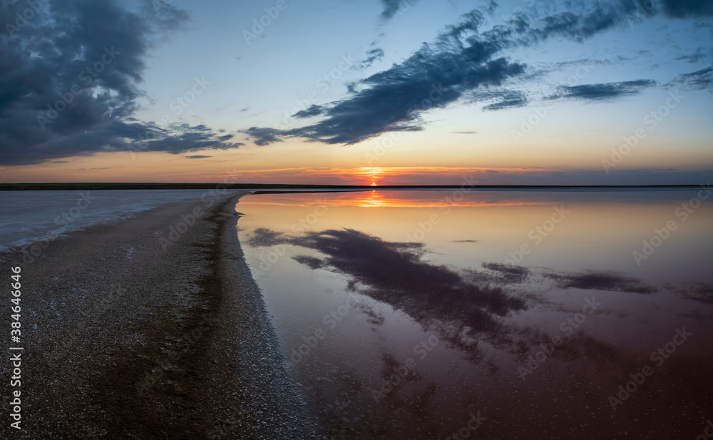 Fototapeta premium Sunset on the Genichesk pink extremely salty lake (colored by microalgae with crystalline salt depositions), Ukraine.