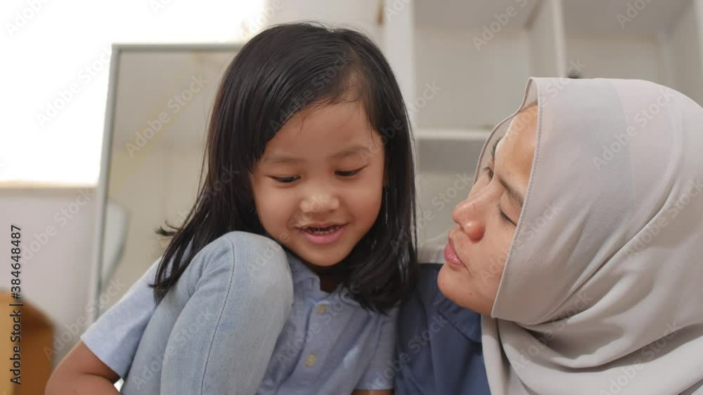 Asian muslim mother drawing with her daughter, single mom teaching baby girl, learning on the floor, happy family Asian muslim mother drawing with her daughter, single mom teaching baby girl, learning on the floor, happy family