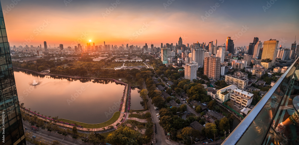 Wide Panoramic View of Bangkok, Thailand. Cityscape with Public Park and Skyscrapers at Sunset.