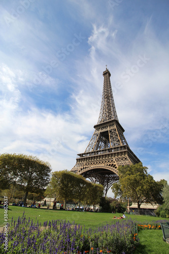 Tourists resting on Eiffel Gardens, Paris, France.