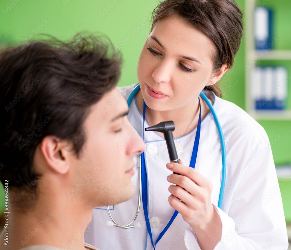 Female doctor checking patient's ear during medical examination Female doctor checking patient's ear during medical examination