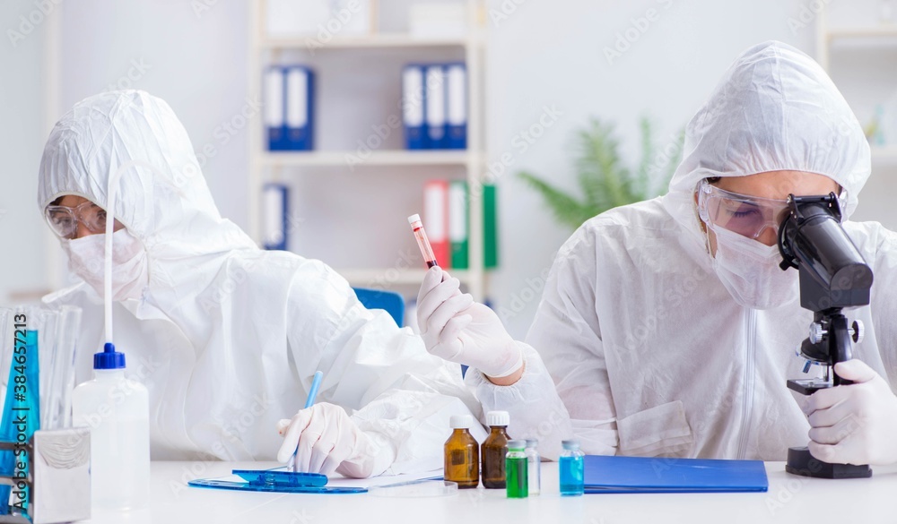 Two scientists working in the chemical lab Two scientists working in the chemical lab