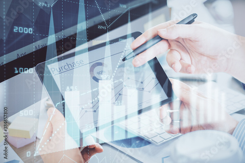 Double exposure of man's hands holding and using a phone and financial chart drawing. Market analysis concept.