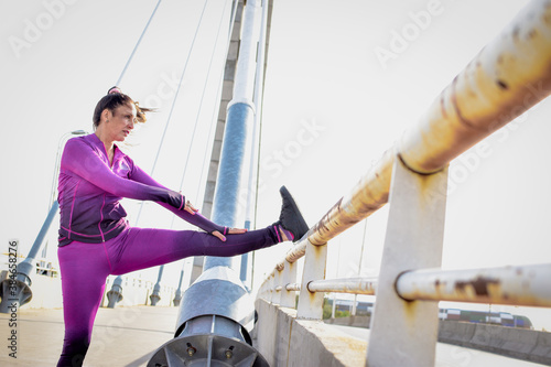 Latin woman doing physical activity outdoors with fitness sportswear