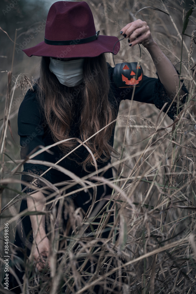 Young beautiful enchantress walking in the forest, with a mask on Young beautiful enchantress walking in the forest, with a mask on