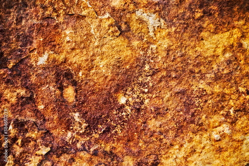 Flat organic rock surface, rusty red and beige.