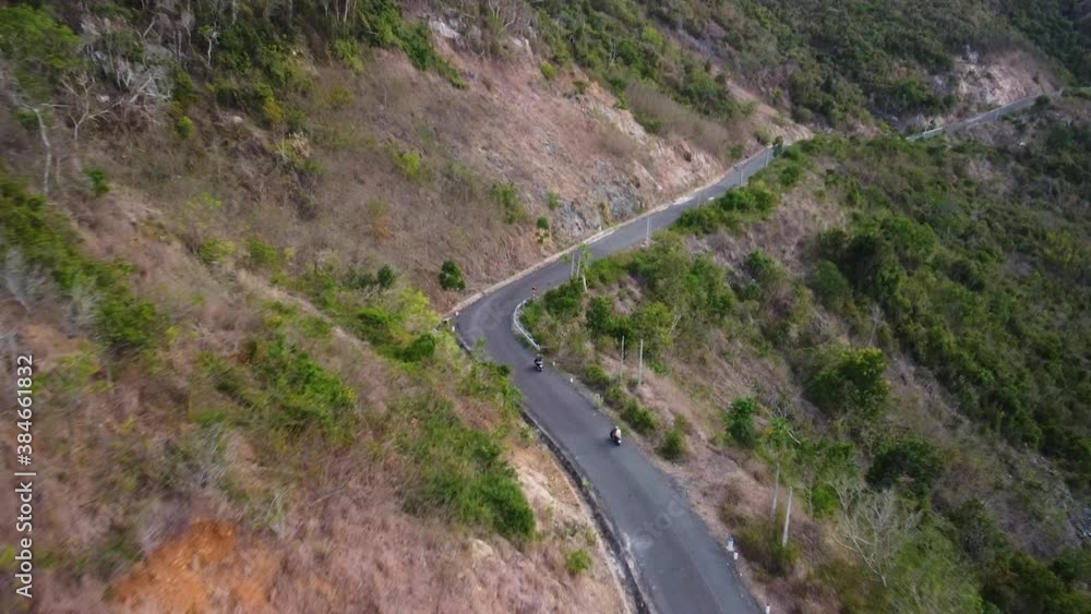 Aerial over motorists traveling at countryside road on the edge of the mountain Aerial over motorists traveling at countryside road on the edge of the mountain