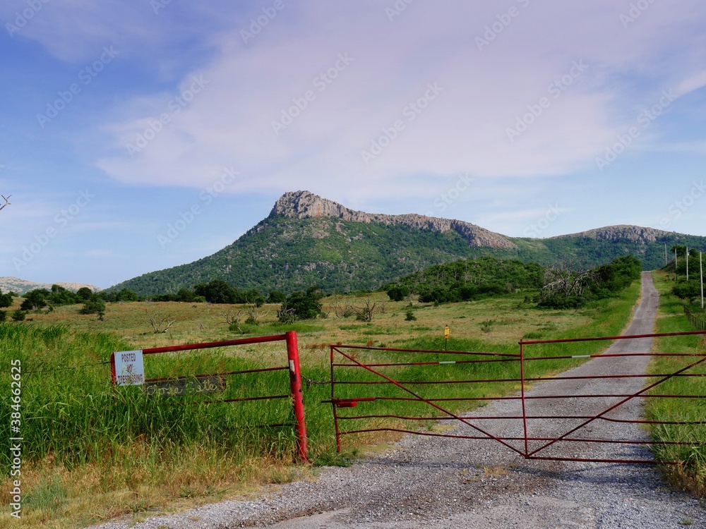 Fenced property with the Wichita Mountains in the background, Oklahoma.