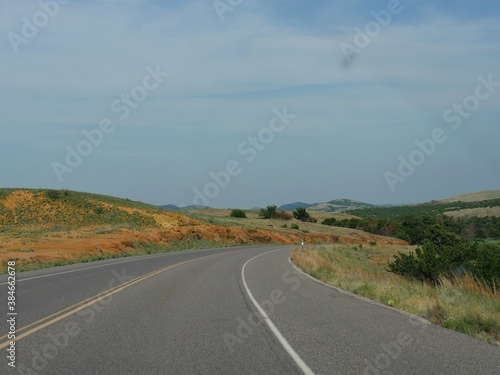 Wide view of a winding road around the Wichita Mountains in Oklahoma.