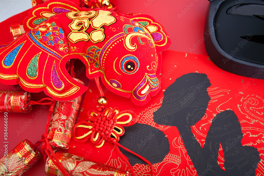 Fototapeta premium Red goldfish hanging ornament on red background.The Chinese characters on spring couplets and hanging fish mean