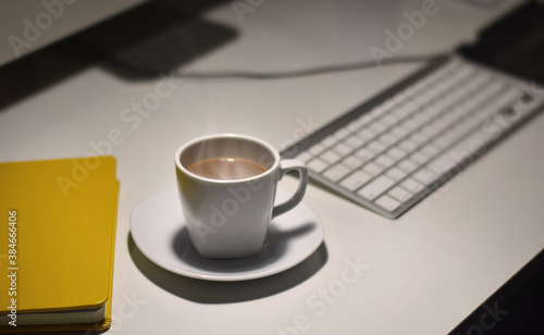 Hot cup of coffee on the desk
