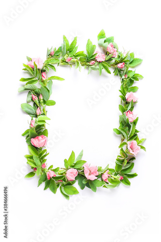holiday layout. beautiful frame of fresh flowers on a white background. pink buds and green rose leaves. flat lay, top view