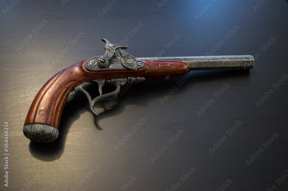 fake black powder gun on table StockFoto Adobe Stock