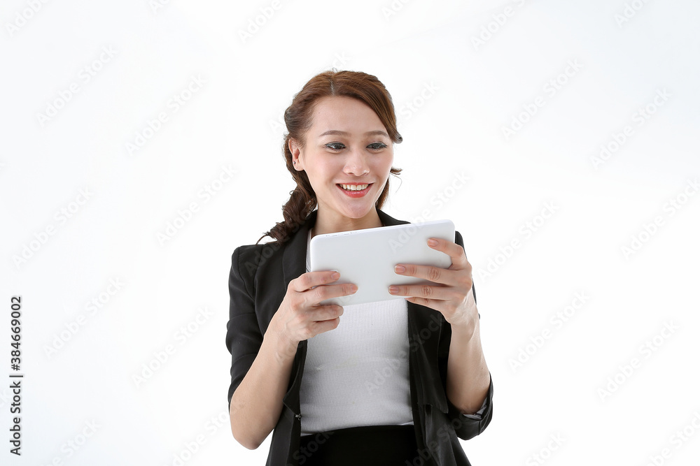 Southeast Asian young office business woman wearing suit holding reading using tablet tab on white studio background Southeast Asian young office business woman wearing suit holding reading using tablet tab on white studio background