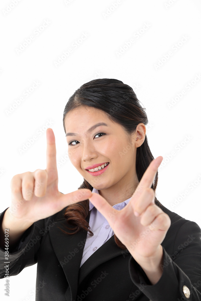 Southeast Asian young office business woman wearing suit framing face with finger smile expression look at camera on white studio background Southeast Asian young office business woman wearing suit framing face with finger smile expression look at camera on white studio background