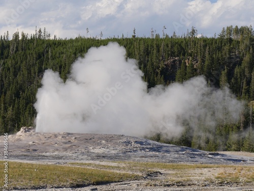 Close up of billows of steam and scalding water spurting out of Old Faithful Geyser during one its regular eruptions at Yellowstone National Park.