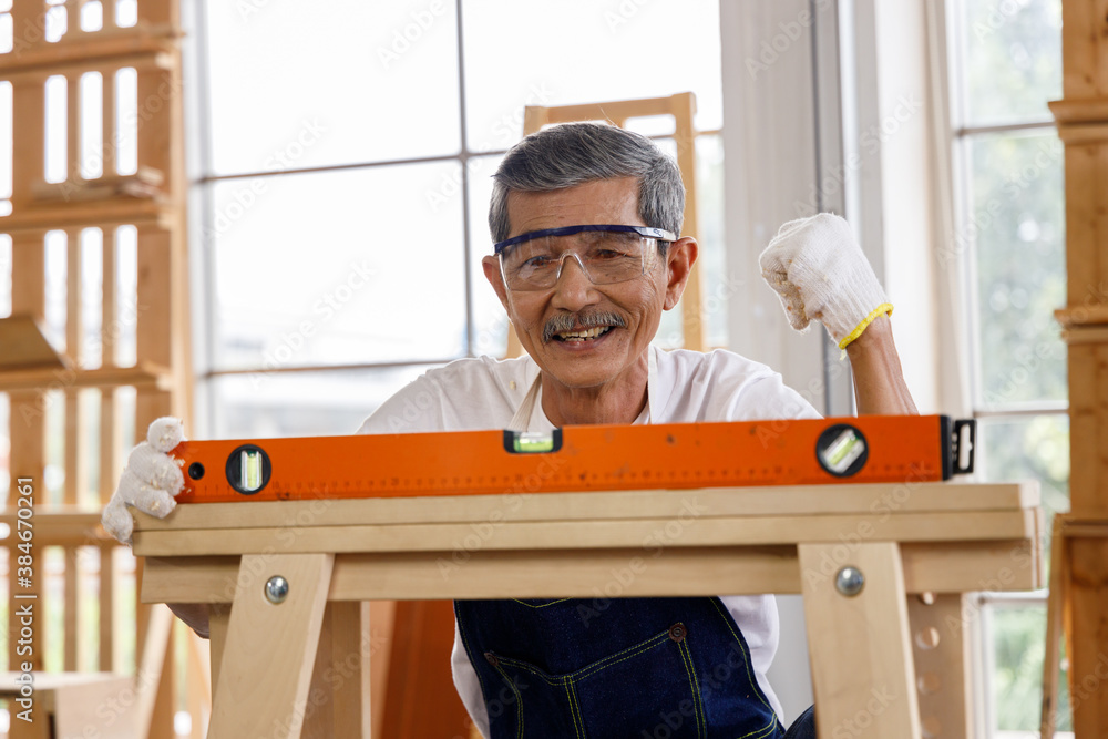 Senior man use level tool to measure surface of wooden board. Senior man use level tool to measure surface of wooden board.