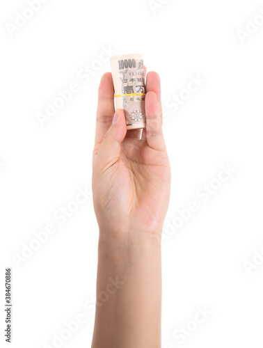 A hand holding Japanese yen banknotes on white background