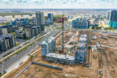 construction of new residential area. aerial view of the construction site, working construction crane and new buildings