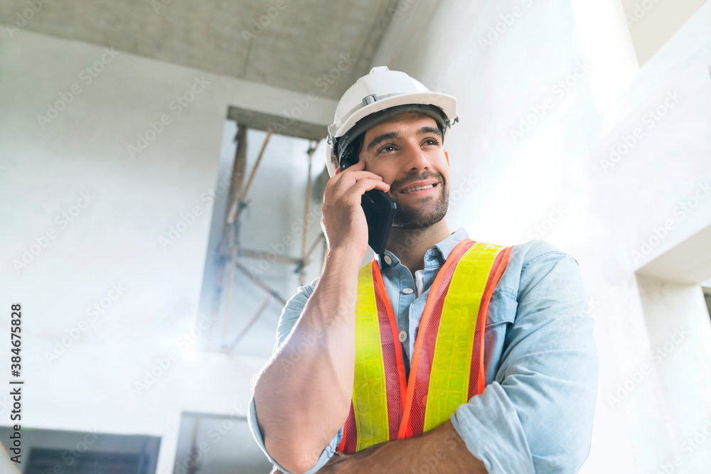 portrait of young caucasian male engineer wearing uniform and hard hat hand use smartphont communication in site construction background portrait of young caucasian male engineer wearing uniform and hard hat hand use smartphont communication in site construction background