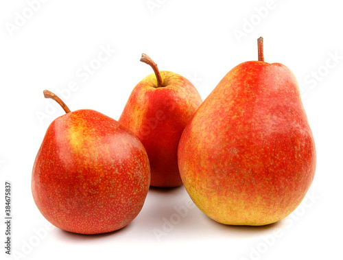 Three ripe pears are isolated on a white background.