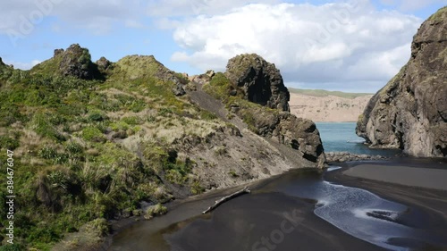 Aerial fly up rocks revealing sea cliff Nature Beauty Whatipu Beach Wonga Wonga Bay photo