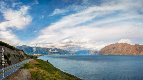 Lake Hawea Lookout Panorama in beautiful late afternoon light with mountain peaks in the distance in Mount Aspiring National Park, Otago Region, New Zealand, Southern Alps.
