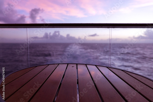 golden twilight senset on wooden curise deck vacation summer time photo