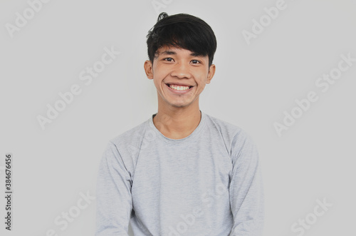 A portrait of a young Asian man looking happy © herukru