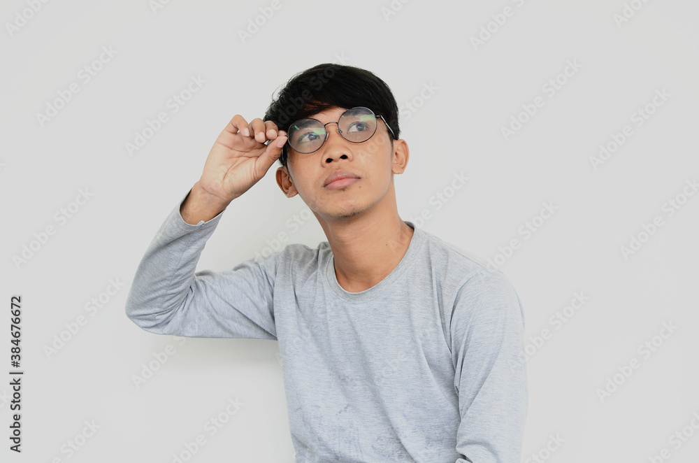 Portrait of Asian man wearing glasses thinking of ideas Portrait of Asian man wearing glasses thinking of ideas